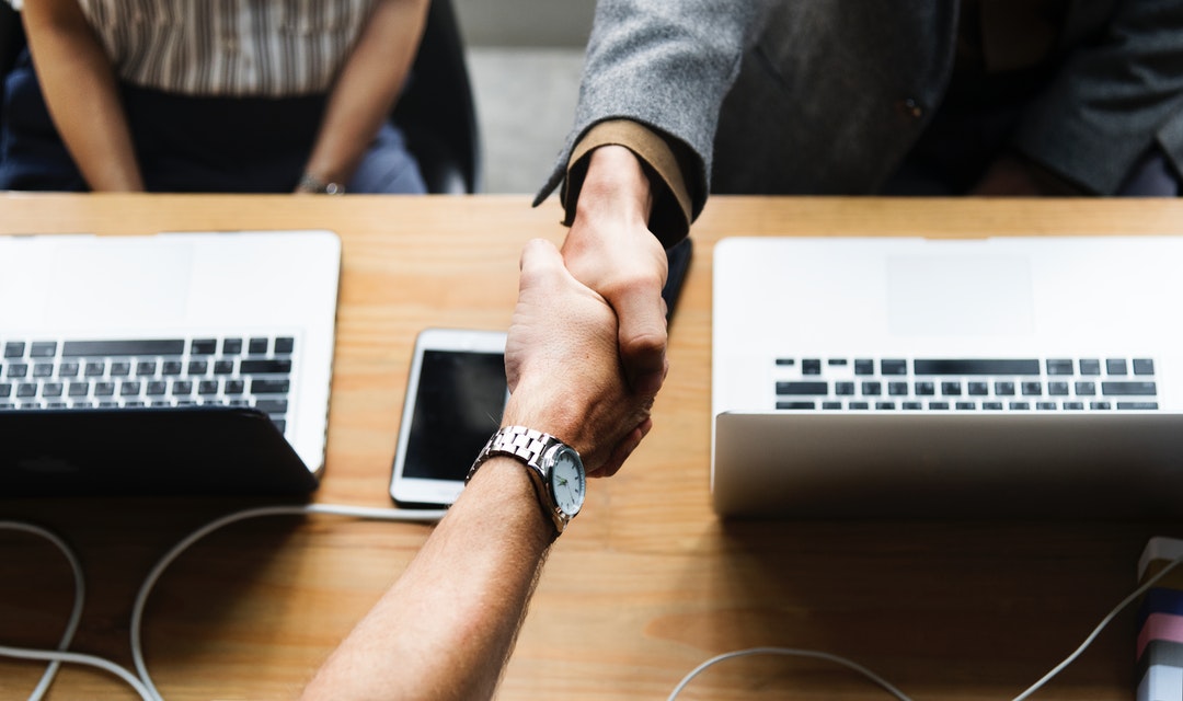 two persons shaking each other's hand
