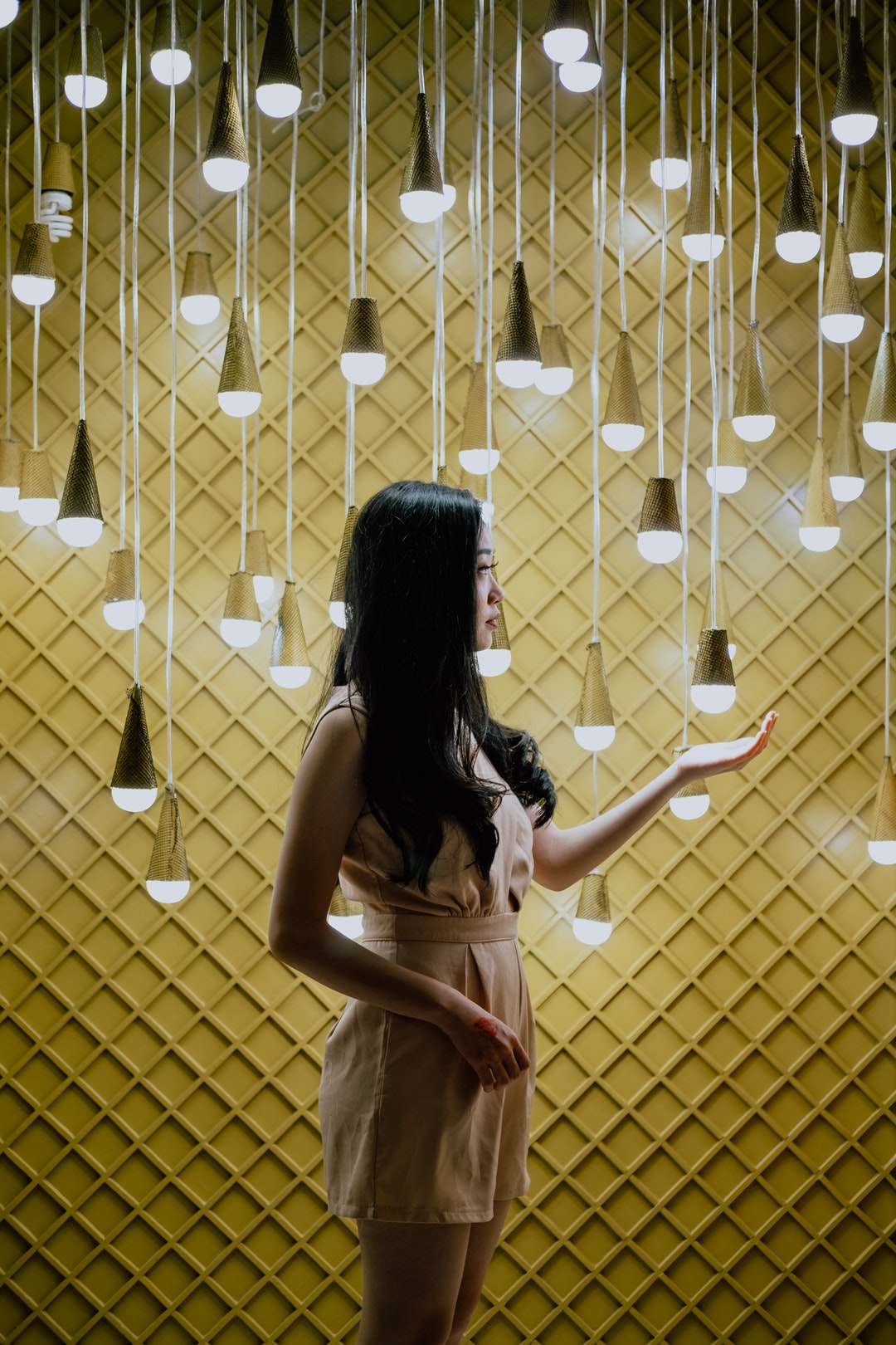 woman about to touch the CFL bulb