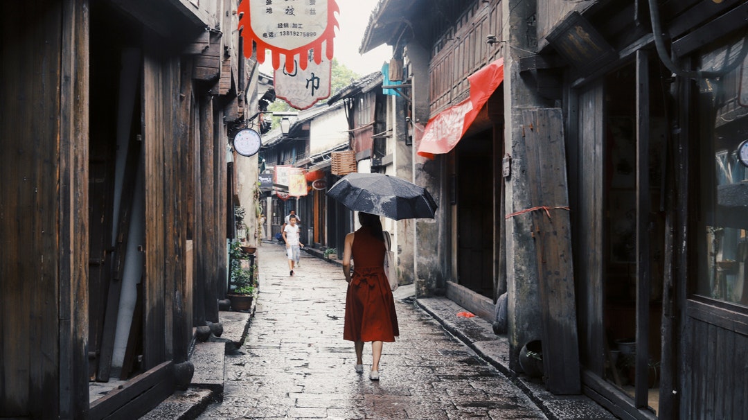 woman holding black umbrella