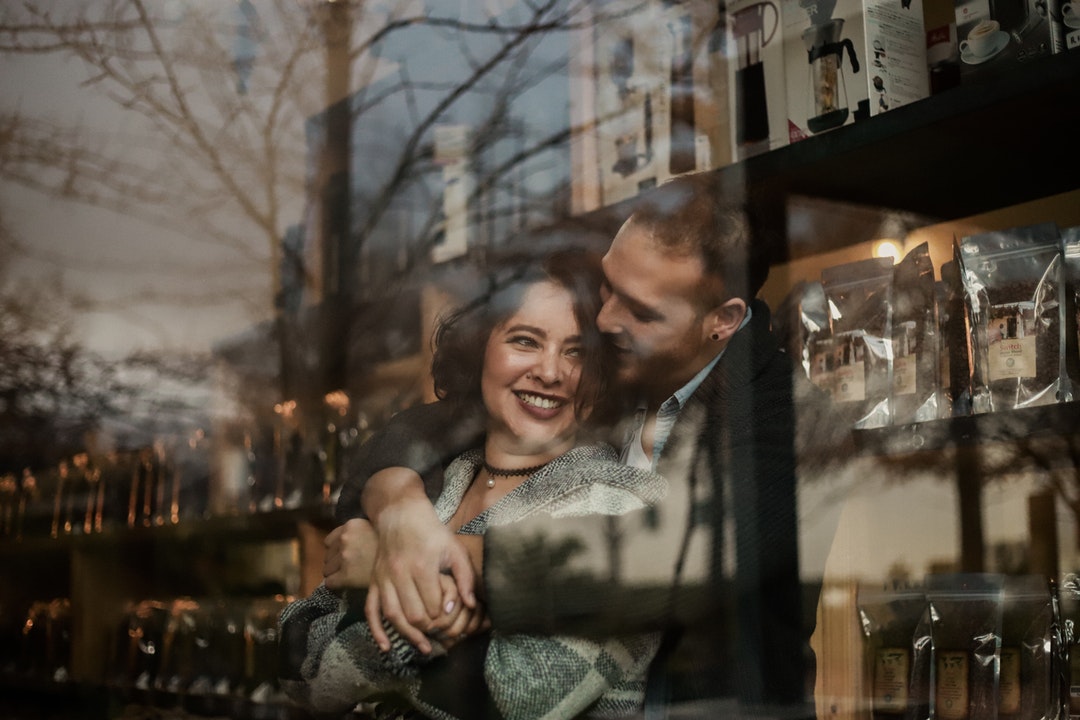 couple hugging inside house