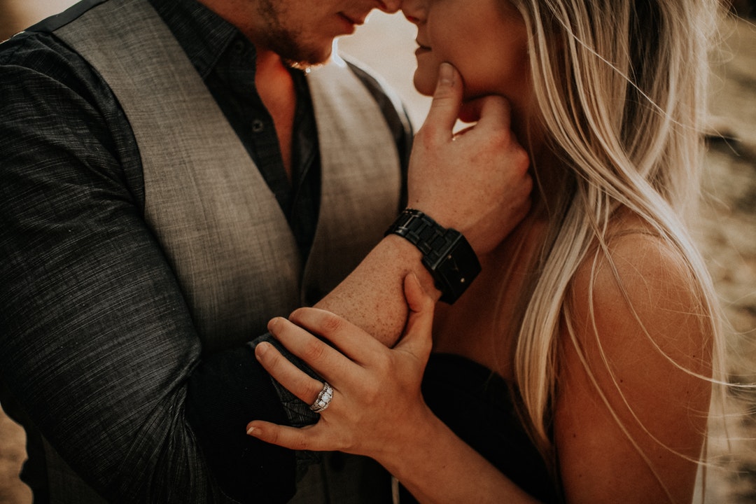 selective focus photography of woman and man about to kiss