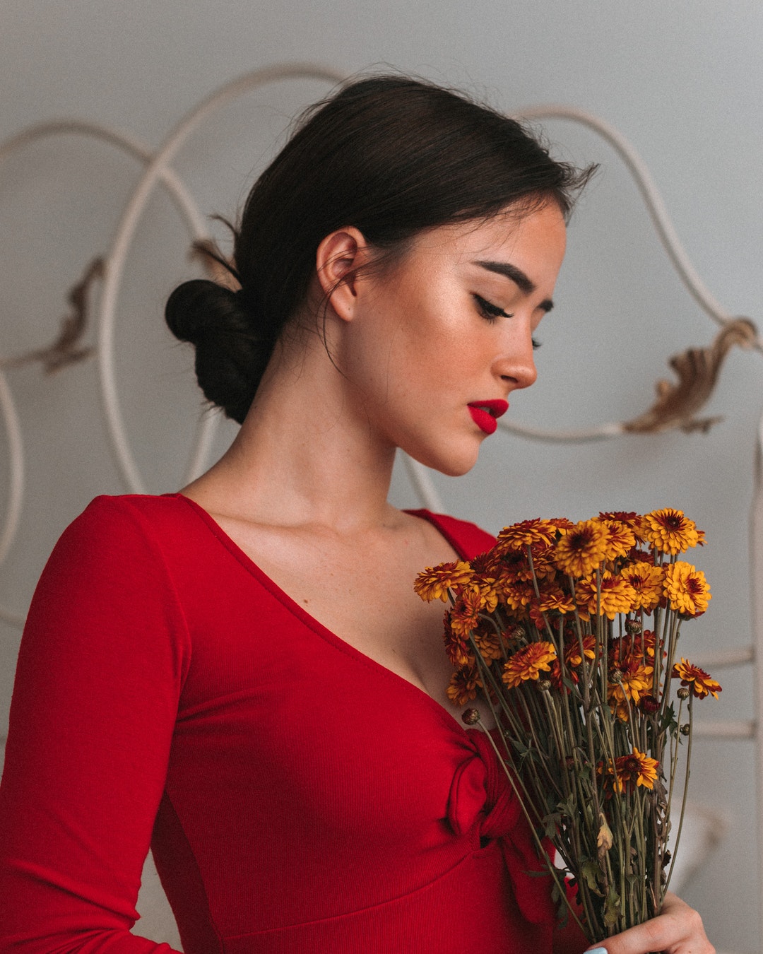 woman holding yellow flowers