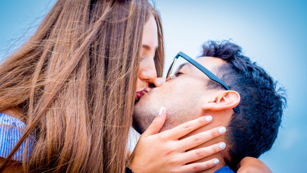 man and woman kissing