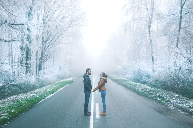 couple standing in an empty road