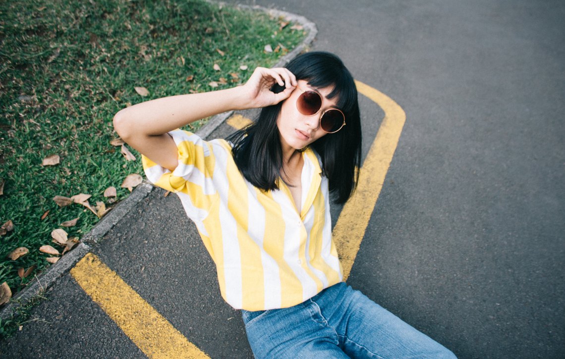 a girl in a yellow striped shirt