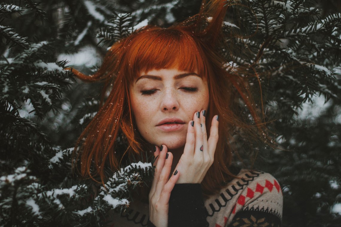 red head in a pine tree