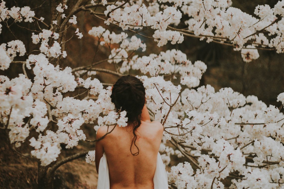 naked woman in a bunch of flowers