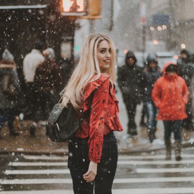Girl walking through city in snow