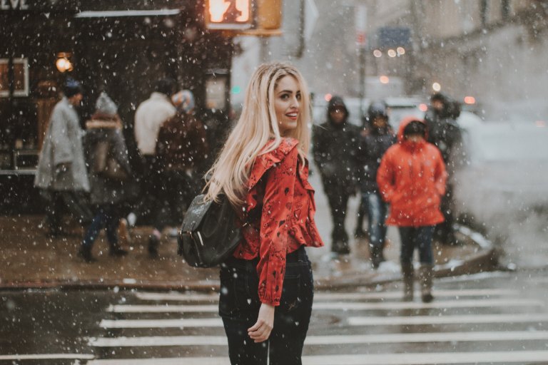 Girl walking through city in snow