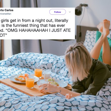 woman sits on bed eating food