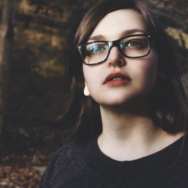 girl in glasses with a septum piercing