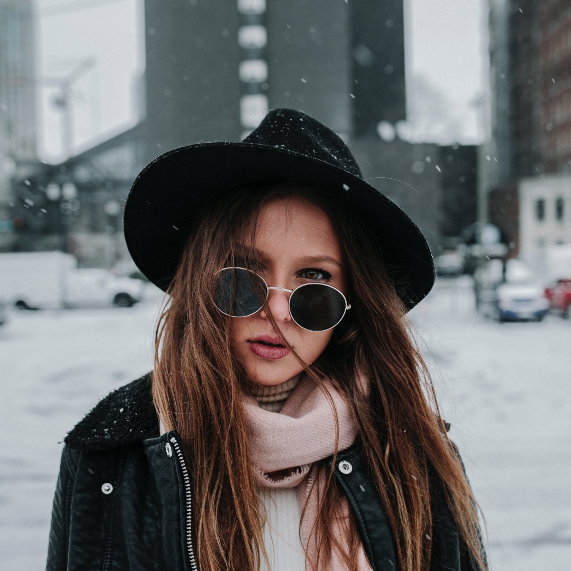 girl in the snow with sunglasses