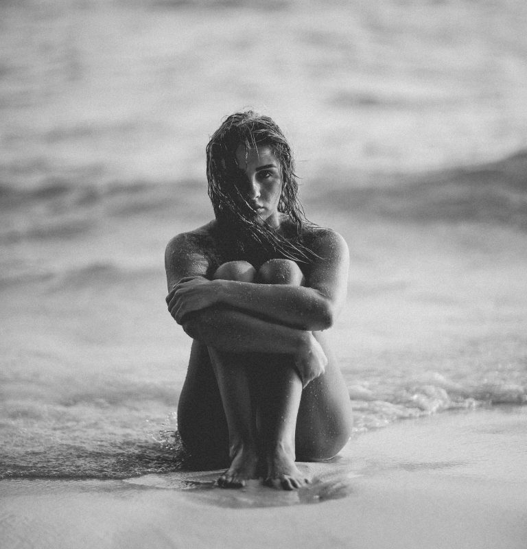 woman sitting on beach