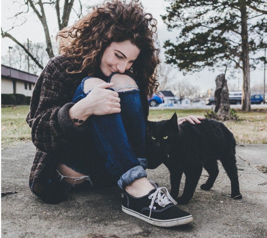 happy girl petting a cat, happy woman, self-love, self-love is a process, loving yourself, learning to love yourself