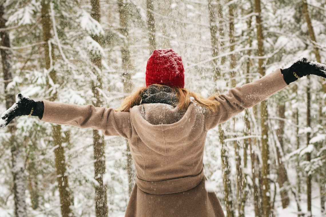girl in the snow arms out