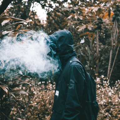 man with smoke all up in his face
