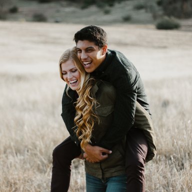 couple giving a piggyback ride in a field