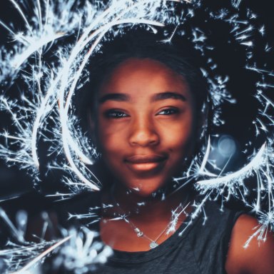 girl with sparklers around her face