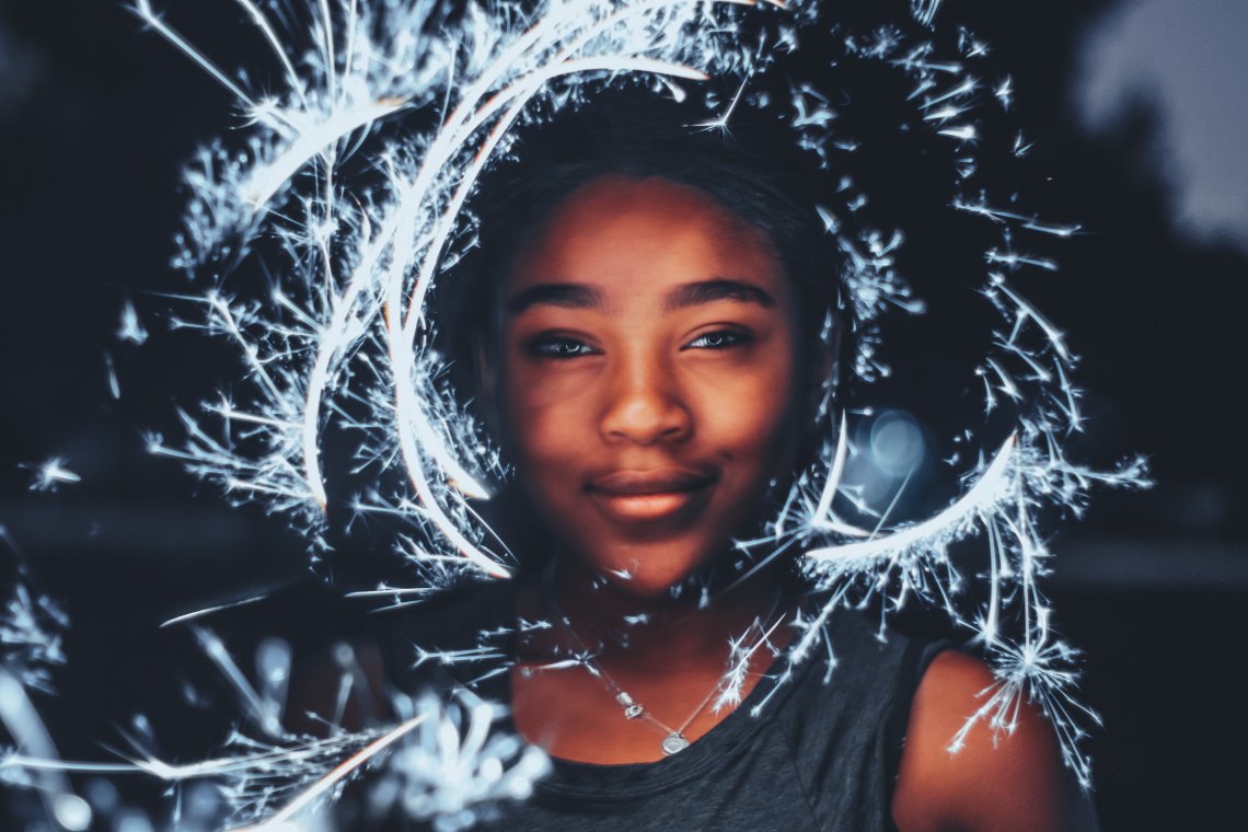 girl with sparklers around her face