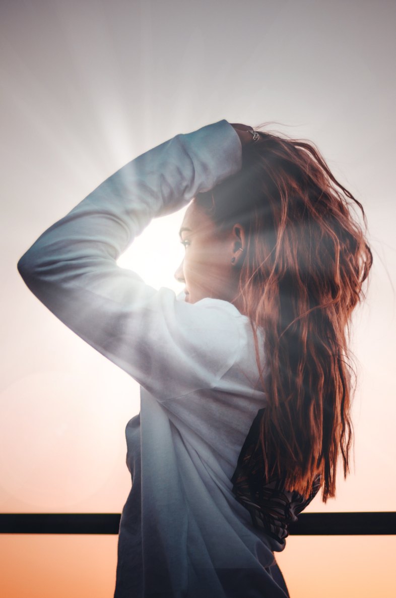 girl standing in front of a sunbeam