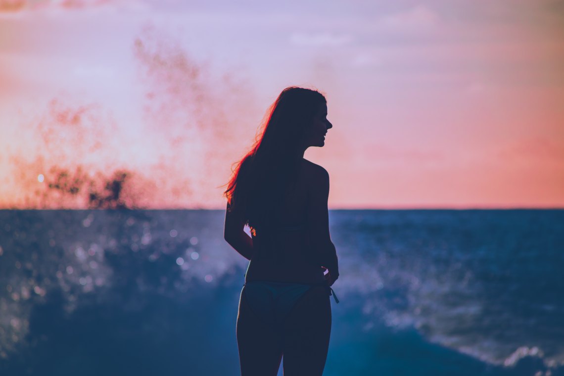 woman standing in front of the ocean