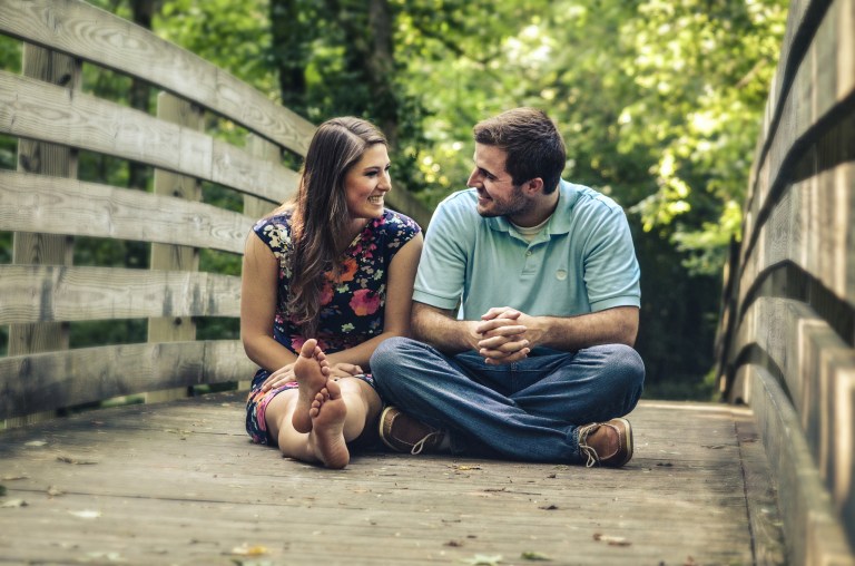 A couple in conversation on a bridge
