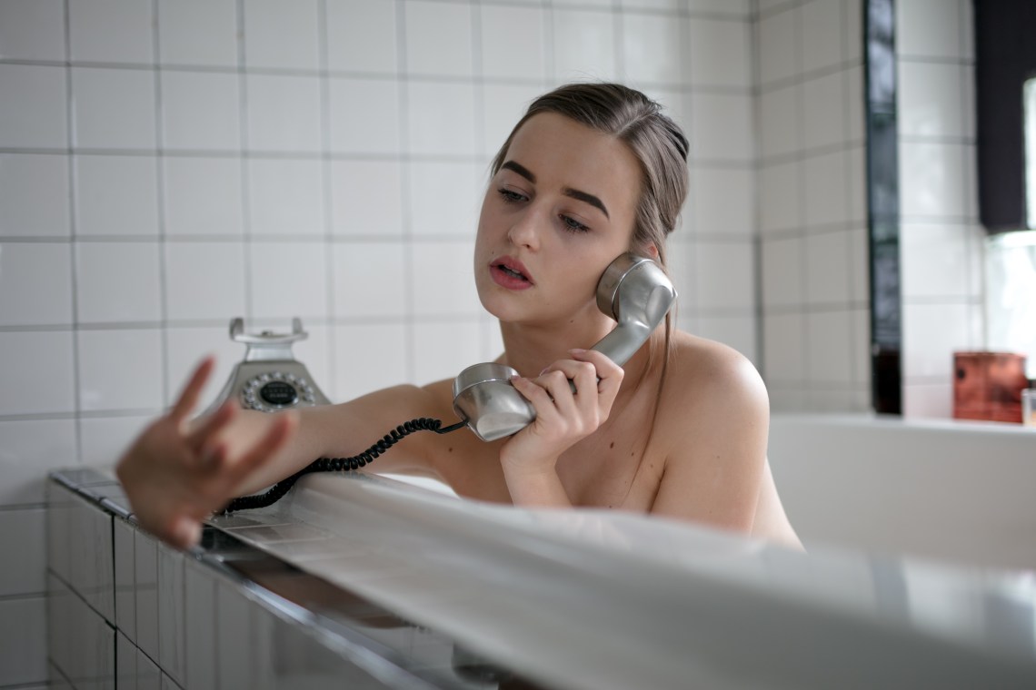 woman calling in bathtub