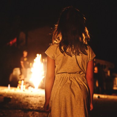 Little girl watches the fire burn, creepy, horror