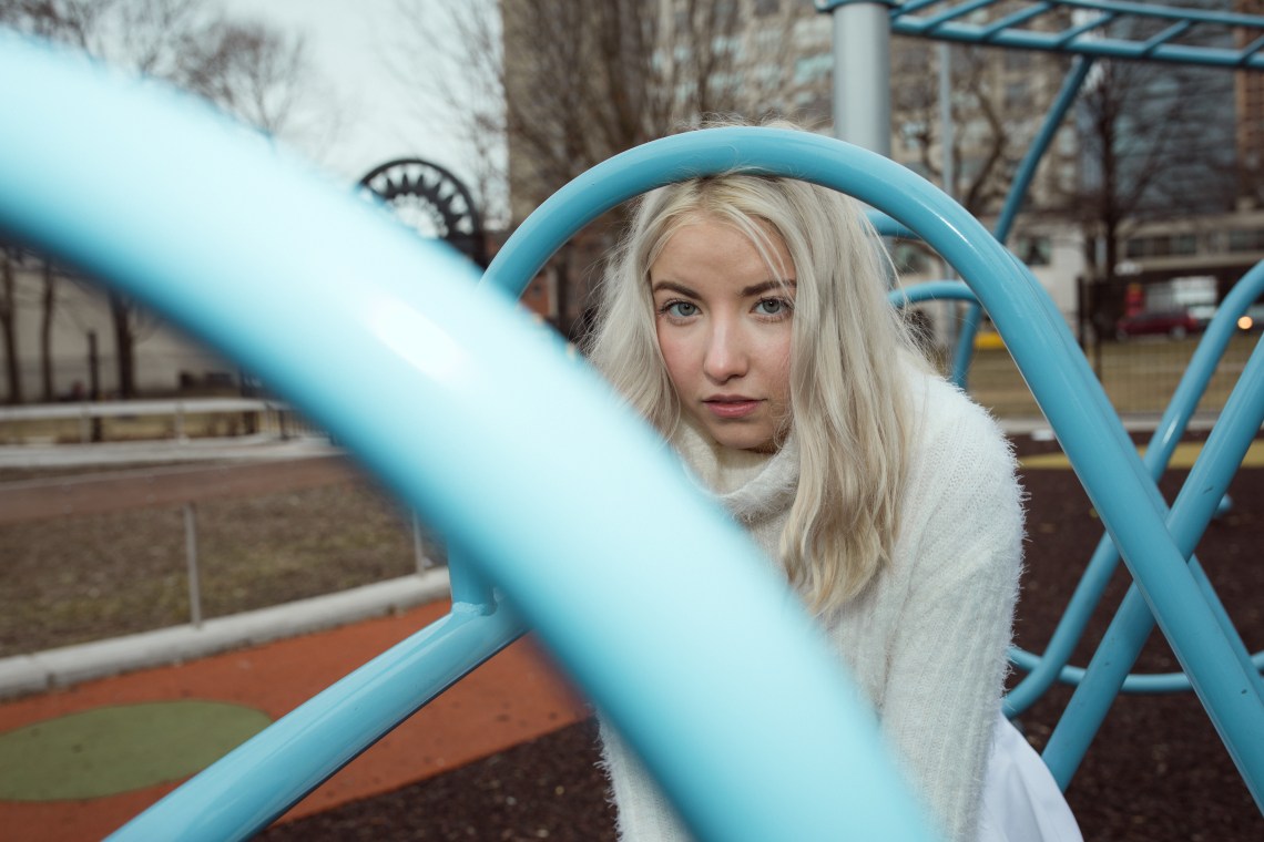 woman sitting on playground thinking