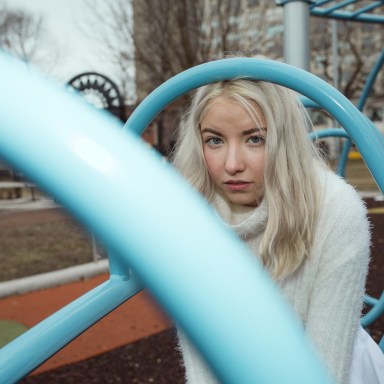 woman sitting on playground thinking