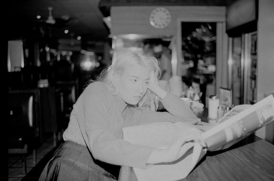woman looking depressed reading newspaper