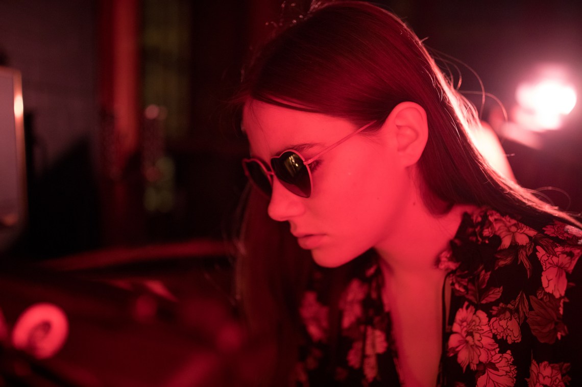 girl in sunglasses and a red light