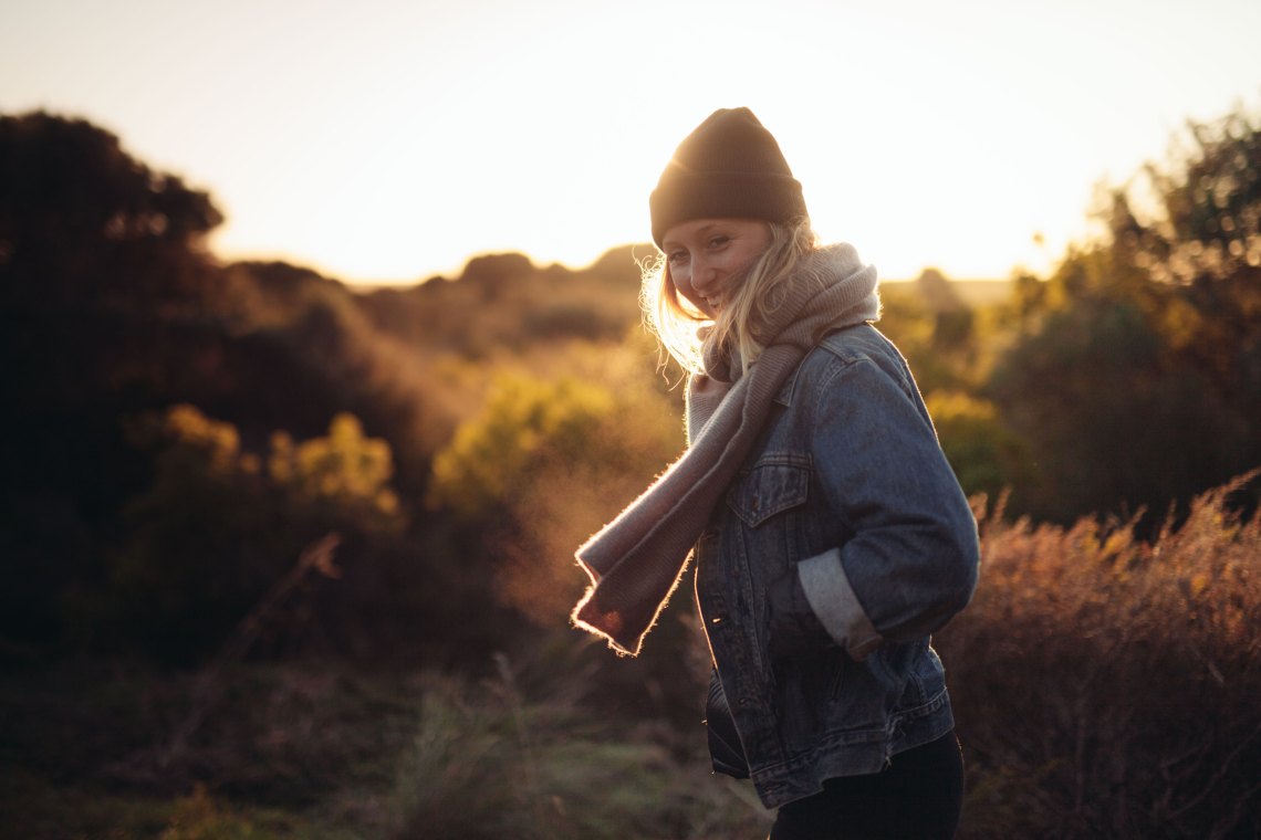 woman standing at sunset in chilly air