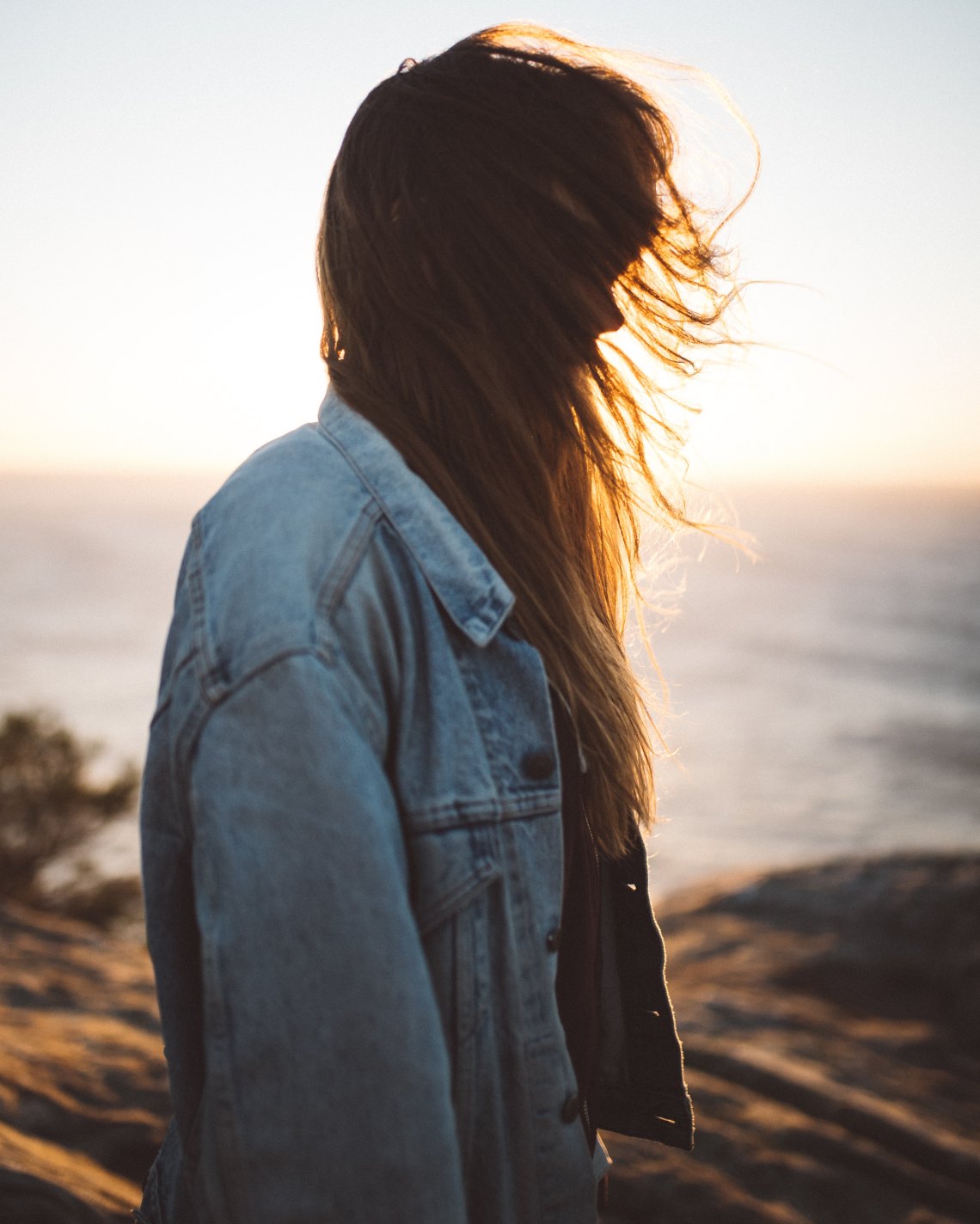 woman faceless standing by water