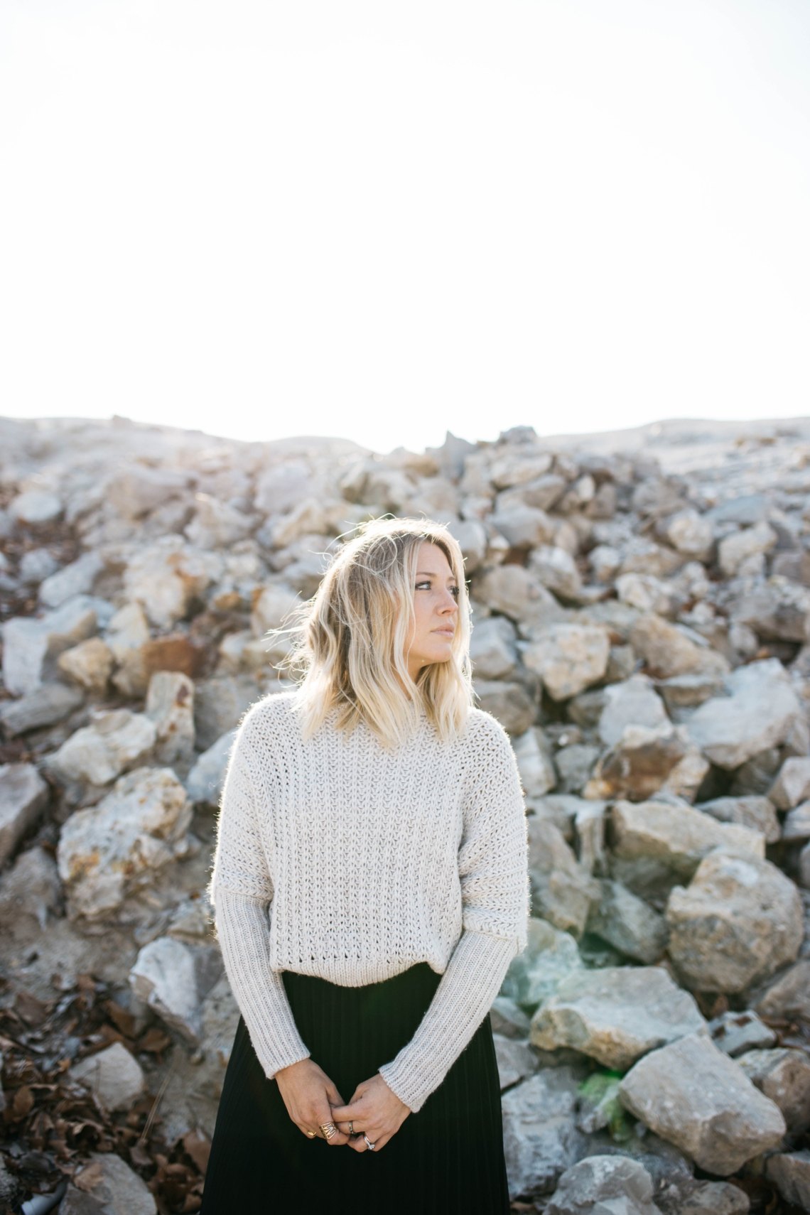 blonde girl by some rocks