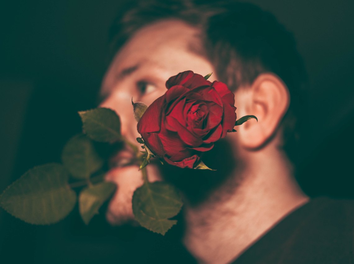 guy holding rose