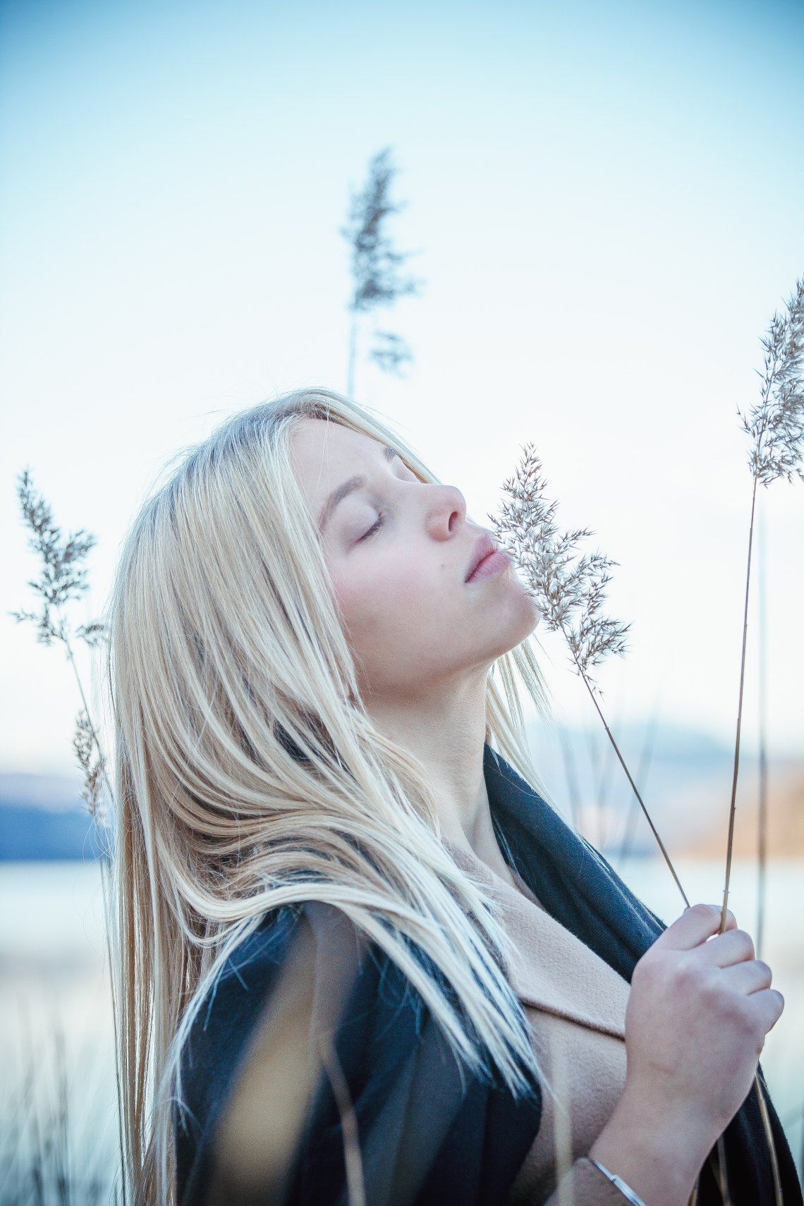 woman standing in field looking hopeful