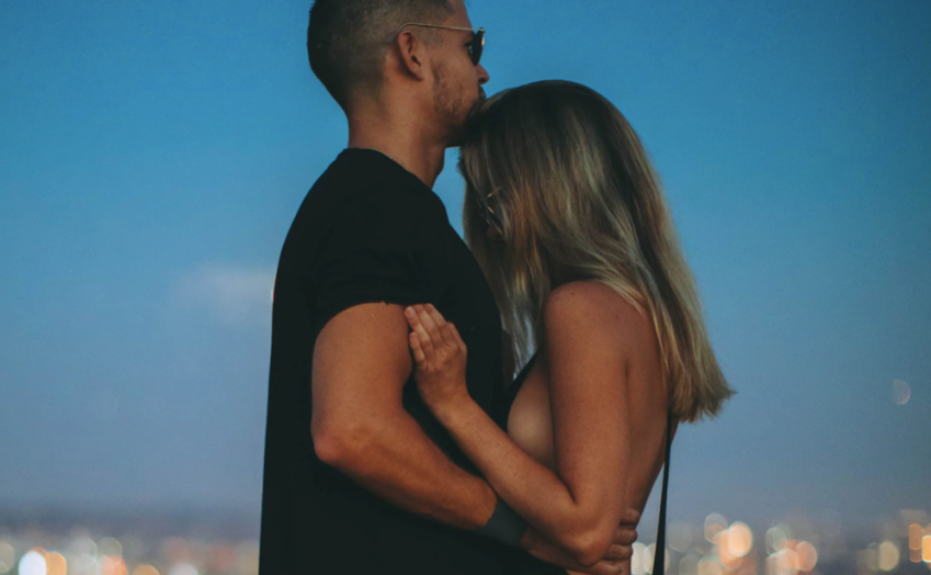 Couple standing over city skyline