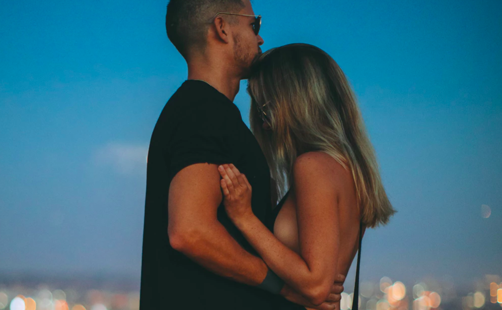 Couple standing over city skyline