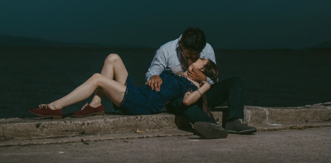 Couple kissing by water