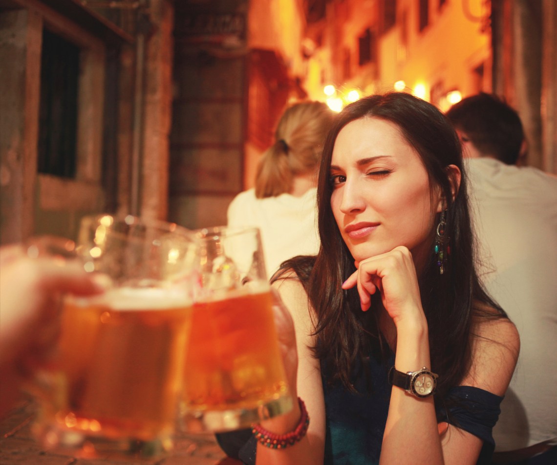 woman cheersing with beer