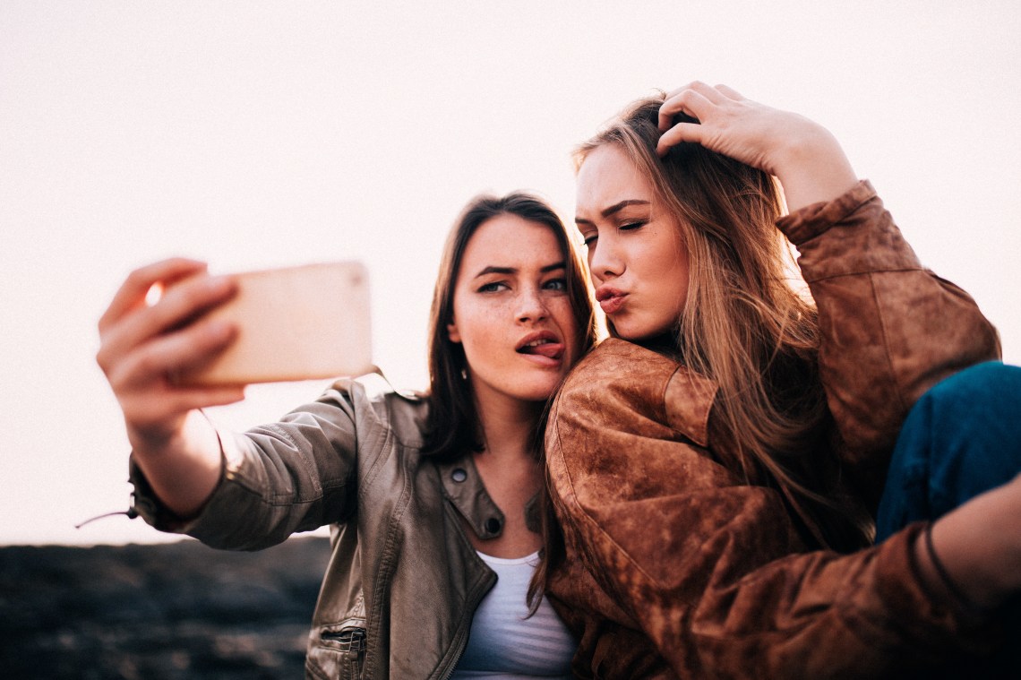 girl friends taking silly selfie