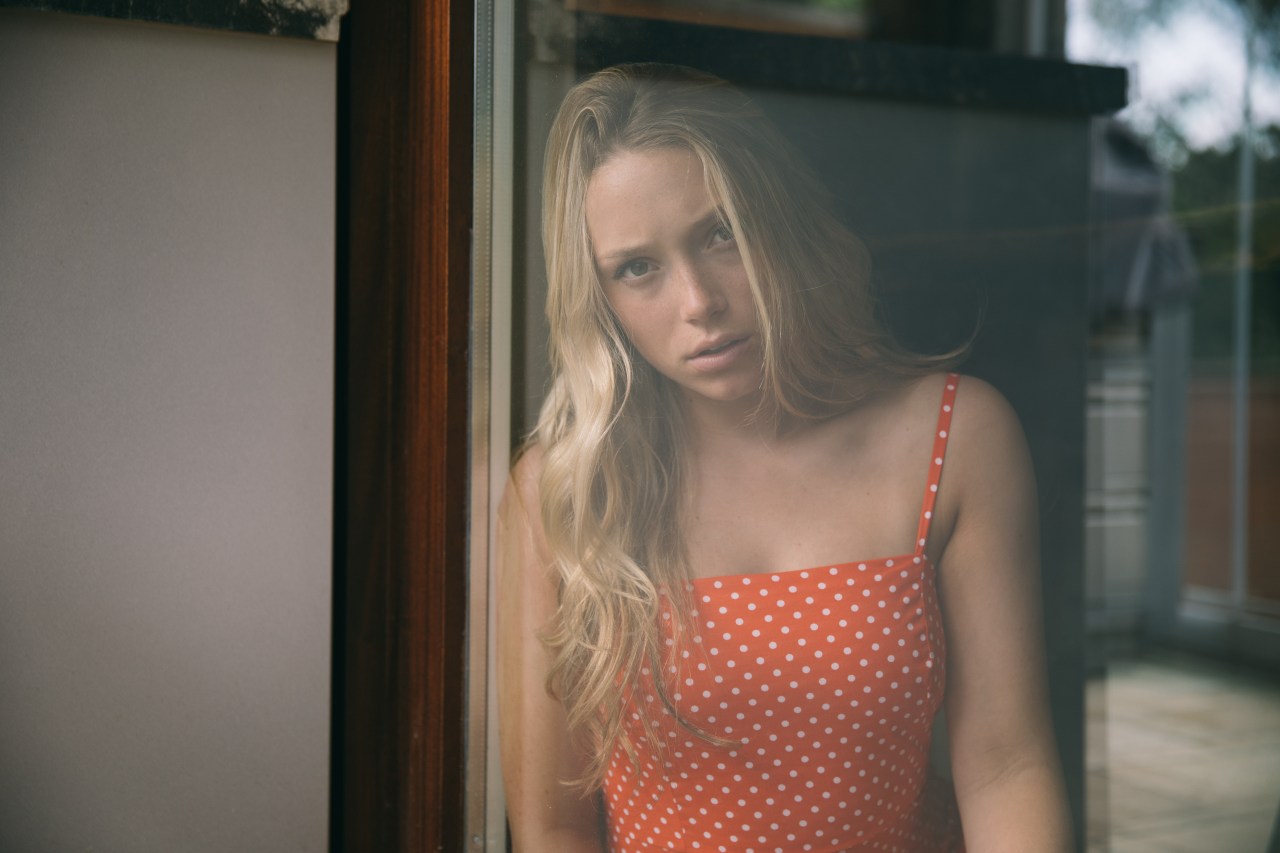 woman looking sad in polka dot dress