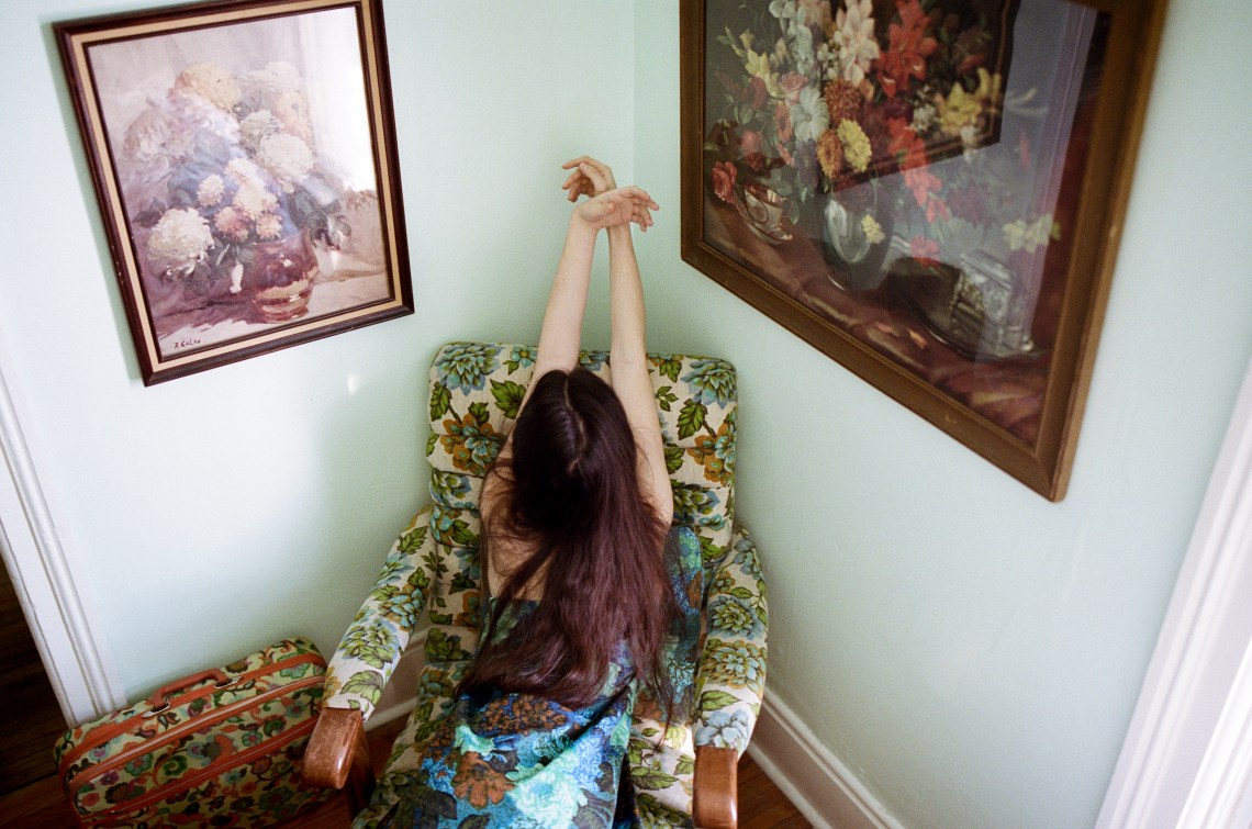 woman sitting on floral chair