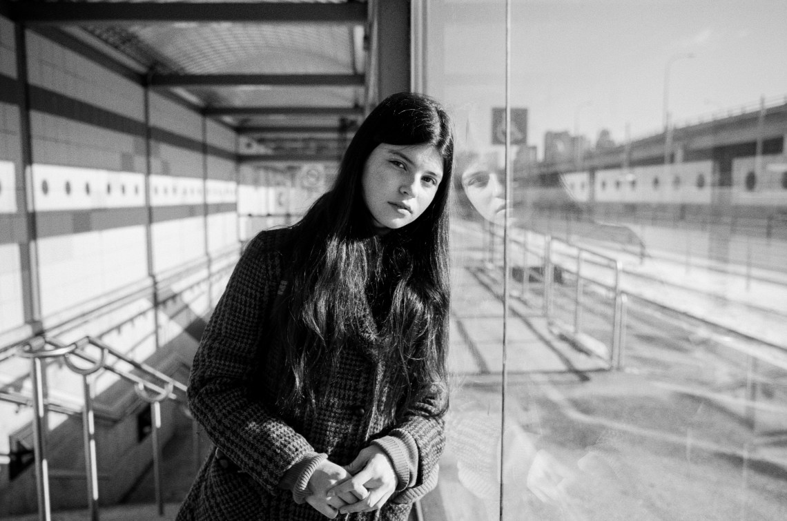 woman standing on subway ledge
