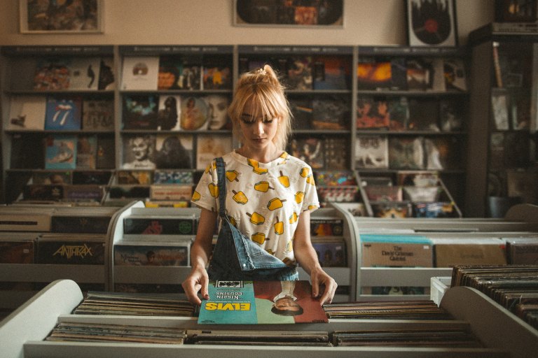 sad girl looking at vinyl records