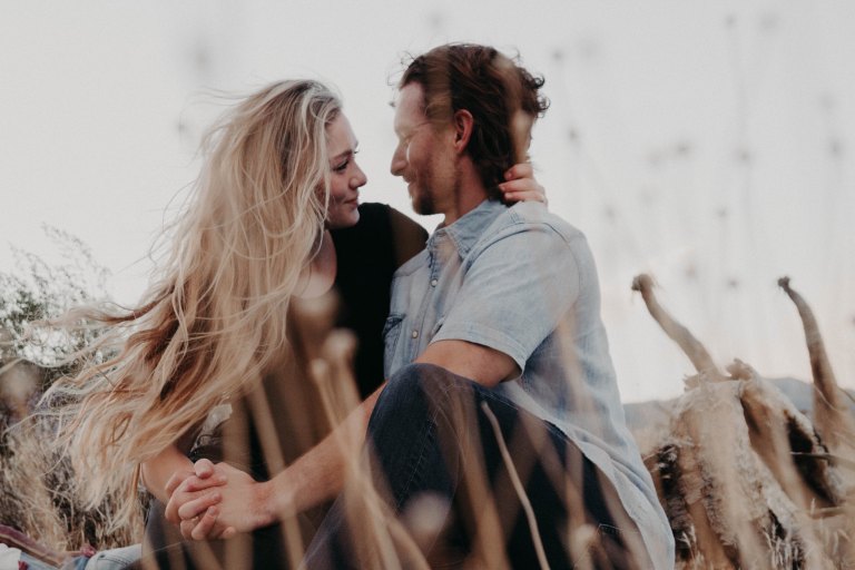 couple embracing in field