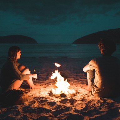 couple sitting together at bonfire