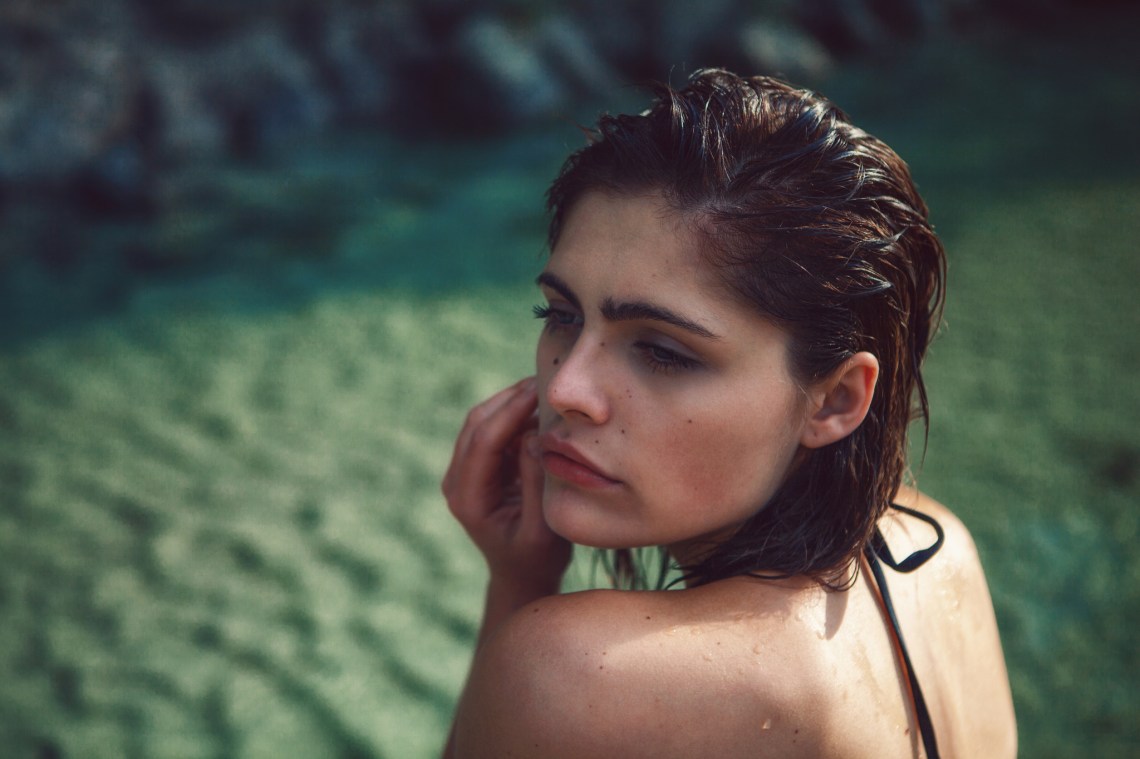 Girl wet from swimming, sandy beach, sad, alone, brave, strong, will be ok