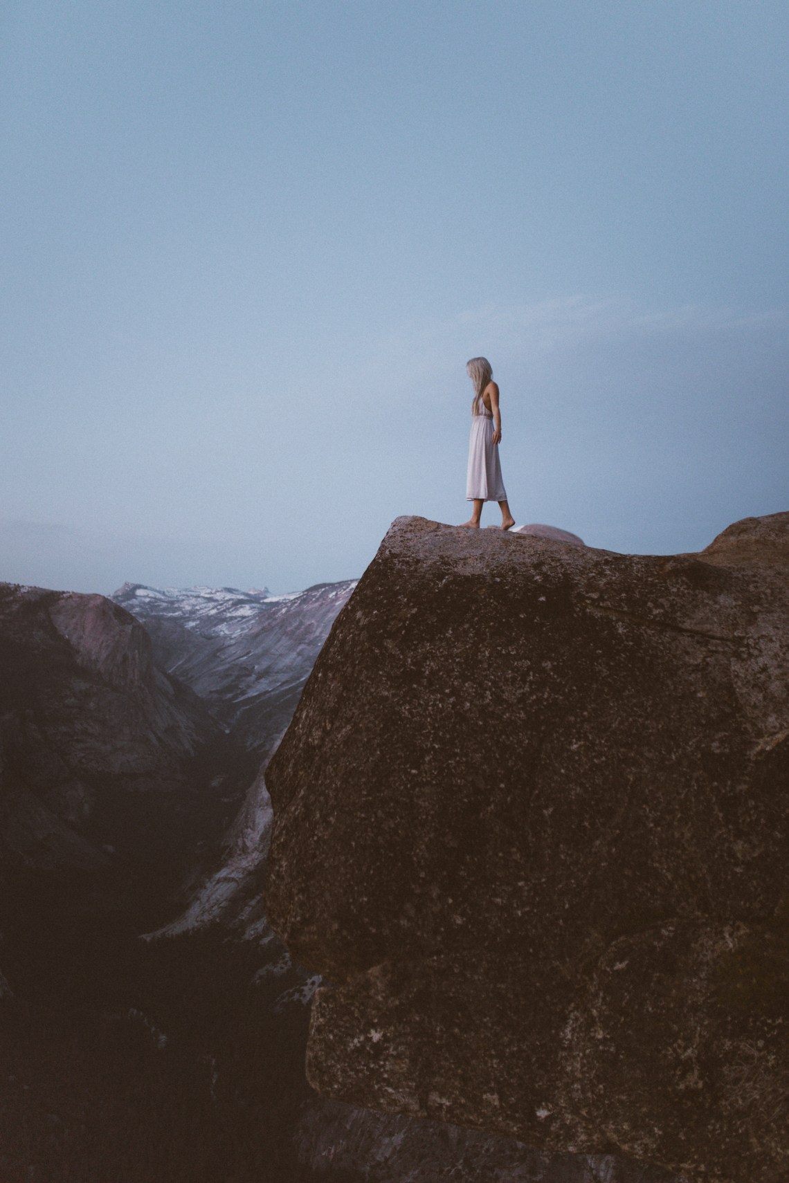 girl in white standing on the mountains